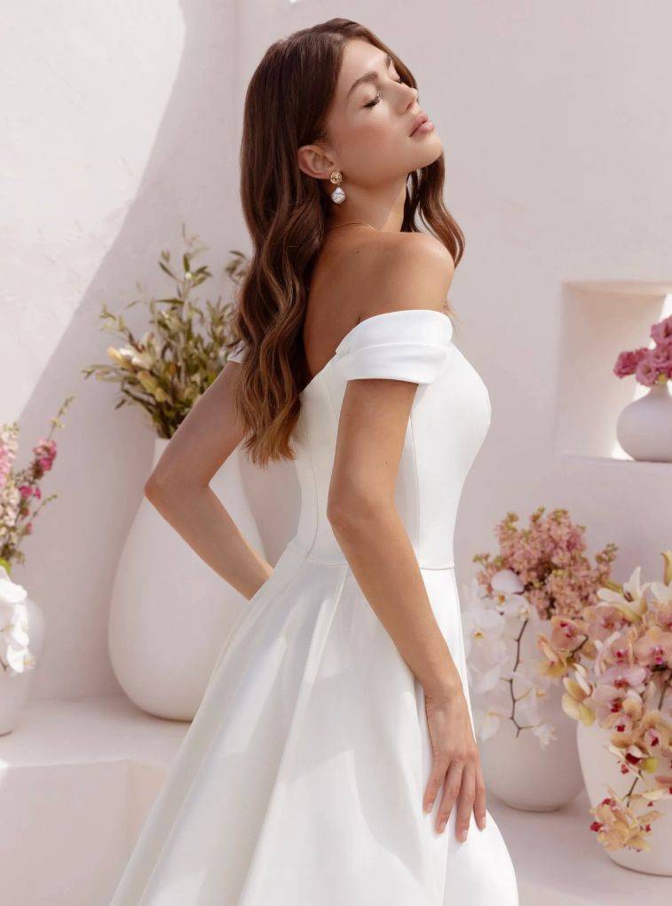 Model wearing a white gown by Le Blanc